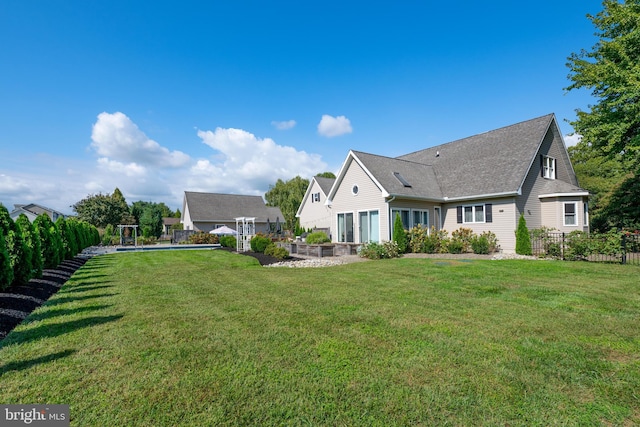 rear view of house with a yard