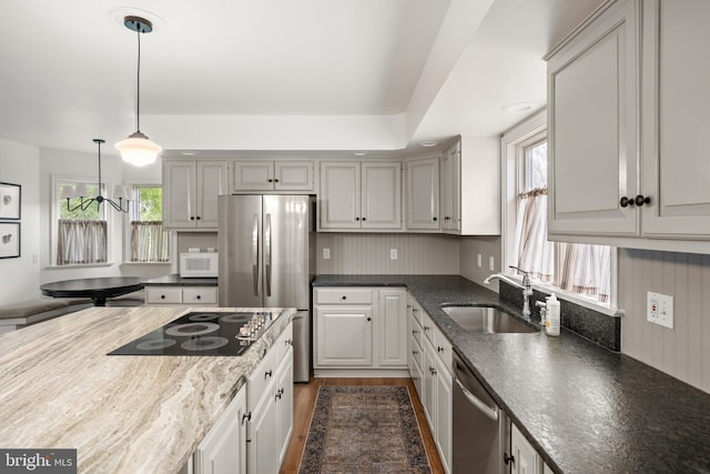 kitchen with appliances with stainless steel finishes, sink, gray cabinets, and plenty of natural light