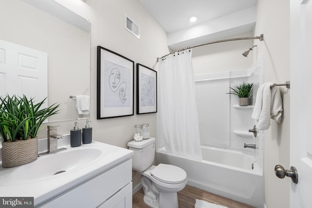 full bathroom with shower / bath combination with curtain, vanity, hardwood / wood-style floors, and toilet