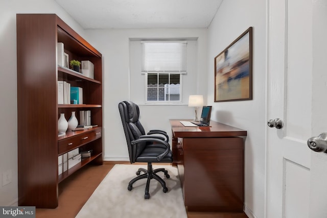 home office with dark hardwood / wood-style floors