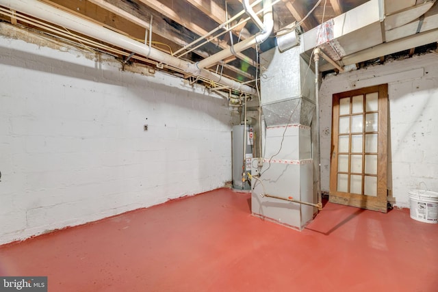 basement featuring heating unit and water heater