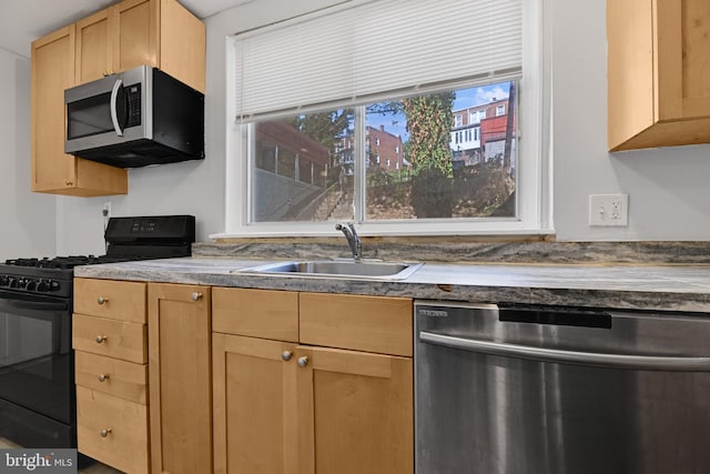 kitchen with light brown cabinetry, sink, and appliances with stainless steel finishes