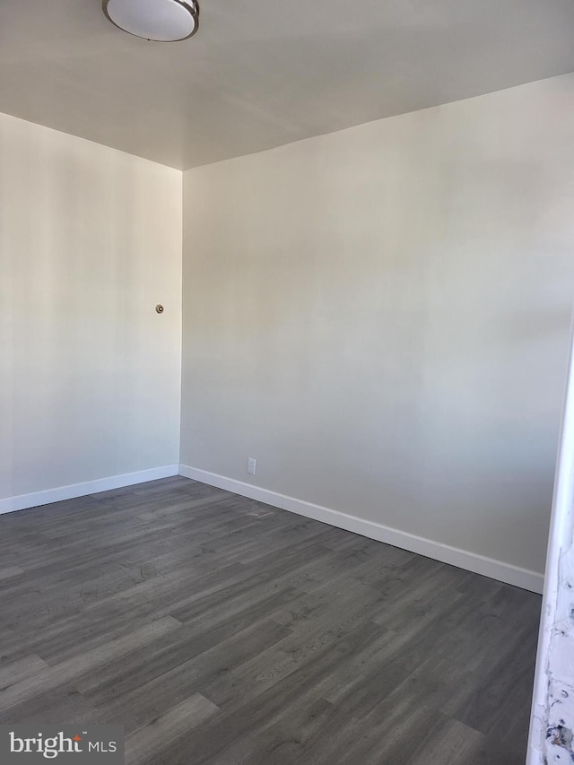 spare room with dark hardwood / wood-style flooring