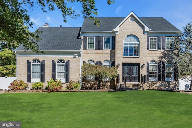 colonial home with a front lawn