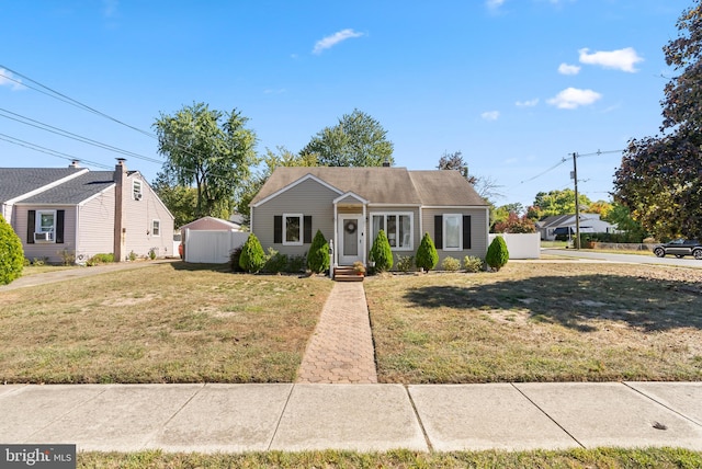 view of front of house featuring a shed and a front yard