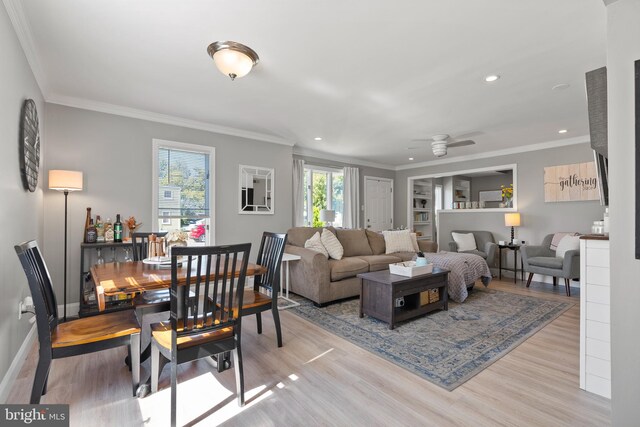 living room featuring ornamental molding, ceiling fan, and light hardwood / wood-style flooring