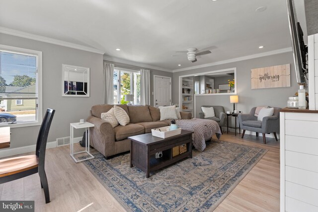 living room featuring light wood-type flooring, crown molding, and ceiling fan