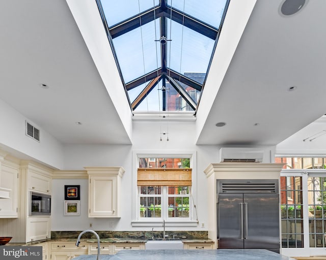 interior space featuring a high ceiling, sink, and a wall mounted AC