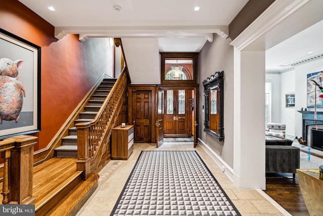 foyer entrance featuring beamed ceiling