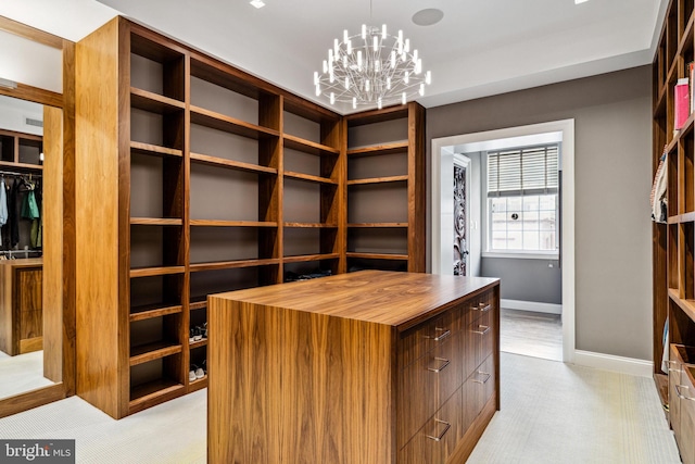 spacious closet with a chandelier