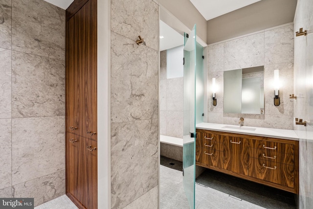 bathroom featuring tile walls, tile patterned floors, and vanity