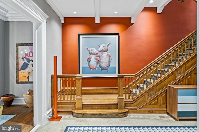 staircase featuring beamed ceiling, hardwood / wood-style flooring, and crown molding