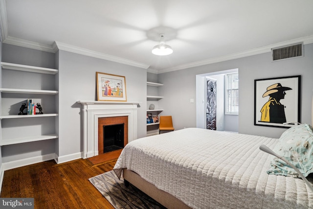 bedroom with ornamental molding and dark hardwood / wood-style flooring