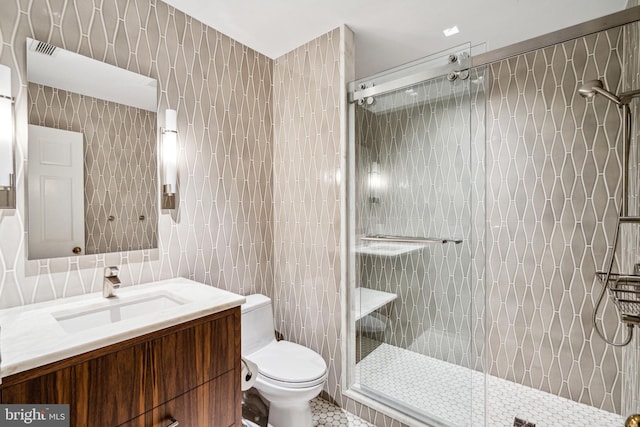 bathroom featuring tile walls, an enclosed shower, tile patterned floors, vanity, and toilet