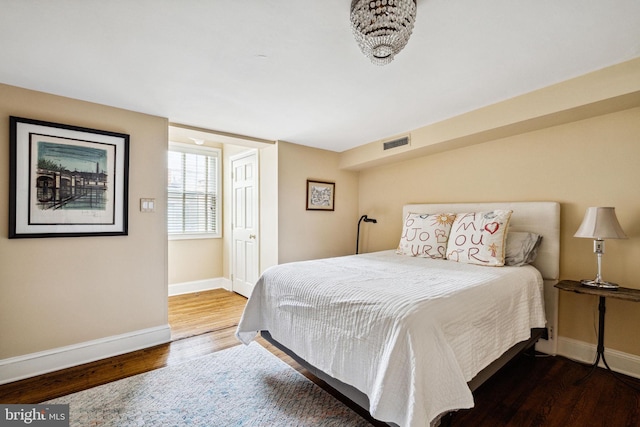 bedroom with dark hardwood / wood-style flooring