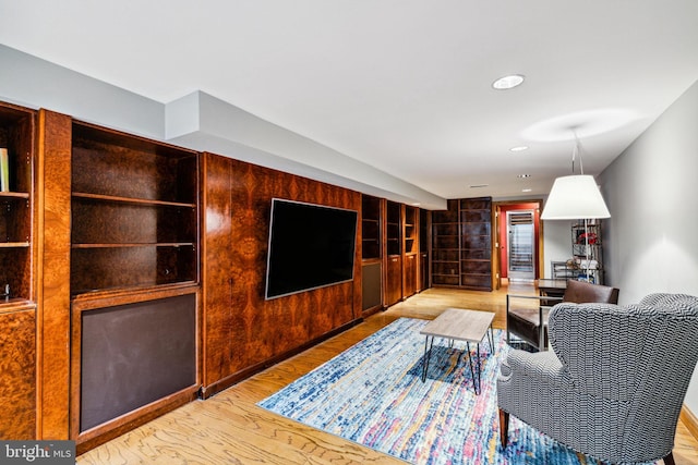 living room featuring light hardwood / wood-style flooring and built in features