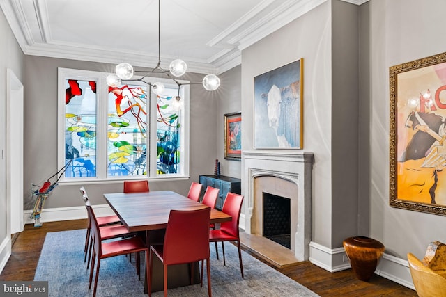 dining space with an inviting chandelier, crown molding, dark hardwood / wood-style floors, and a premium fireplace