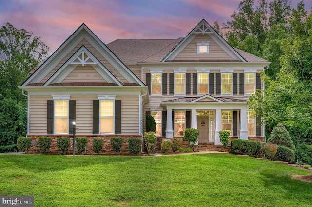 view of front of house featuring a porch and a yard