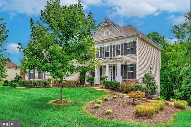 view of front of house with covered porch and a front yard