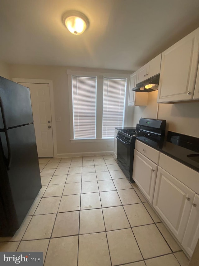 kitchen with white cabinets, black appliances, and light tile patterned floors