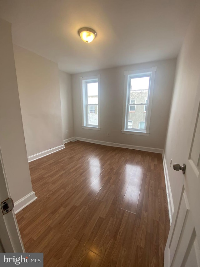 empty room featuring dark hardwood / wood-style flooring