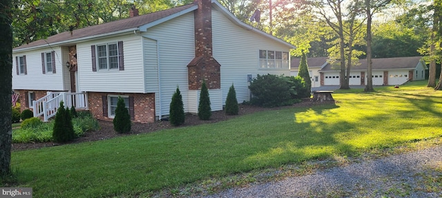 view of side of home with a garage and a yard