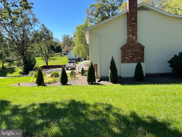 view of property exterior with a yard