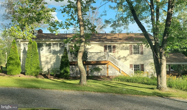 view of front of home featuring a front yard and a deck