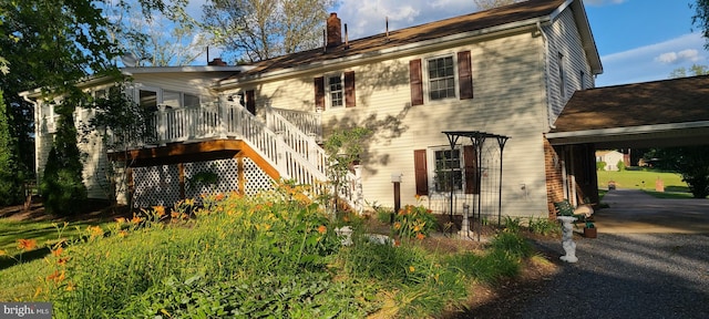 exterior space featuring a carport and a deck