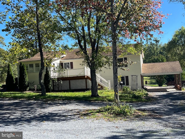 view of front of property featuring a deck and a carport