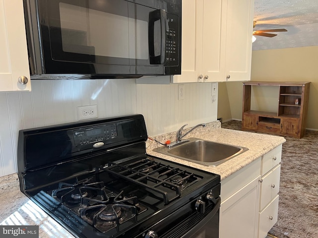 kitchen with ceiling fan, carpet flooring, sink, white cabinetry, and black appliances