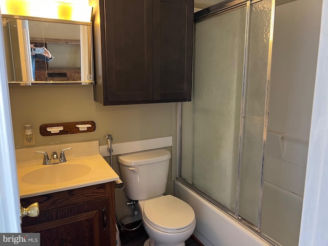 full bathroom featuring vanity, toilet, and combined bath / shower with glass door