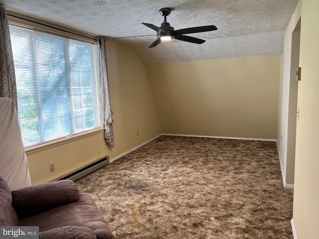 additional living space featuring a textured ceiling, ceiling fan, vaulted ceiling, a baseboard radiator, and carpet flooring