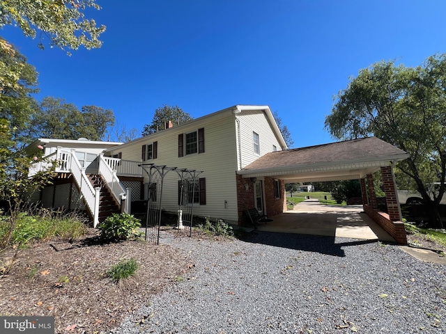 view of front facade with a wooden deck and a carport