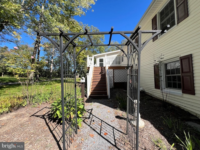 view of yard featuring a wooden deck and a pergola