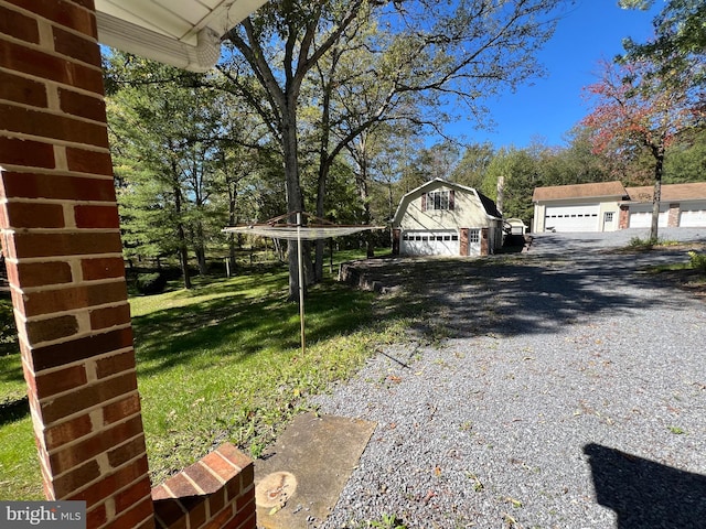 view of yard featuring a garage and a shed