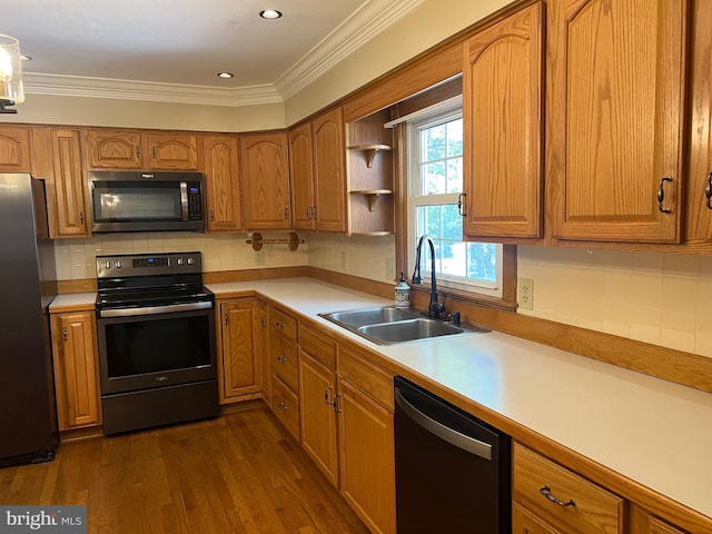 kitchen with tasteful backsplash, sink, dark hardwood / wood-style flooring, crown molding, and appliances with stainless steel finishes