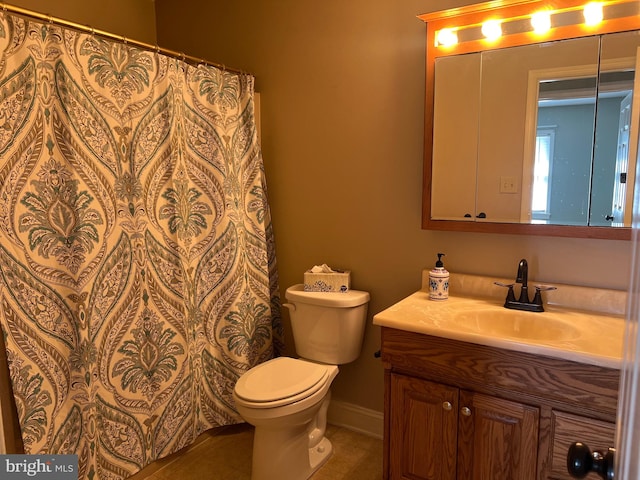 bathroom featuring tile patterned floors, vanity, and toilet