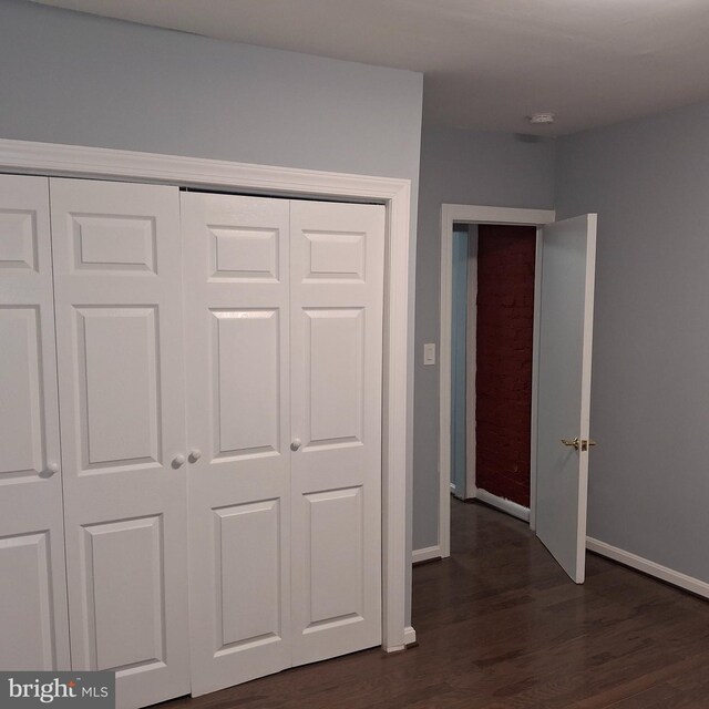 unfurnished bedroom with dark hardwood / wood-style floors