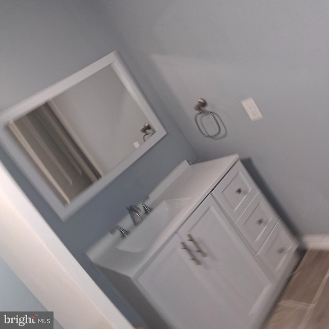 interior space featuring wood-type flooring and vanity