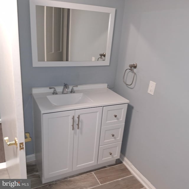 bathroom with hardwood / wood-style floors and vanity