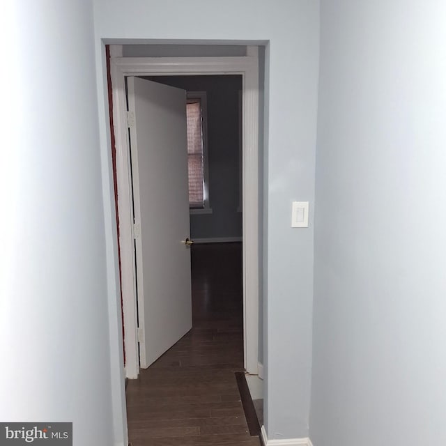 hallway with dark wood-type flooring