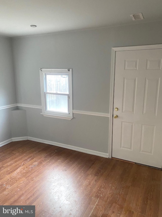 spare room with hardwood / wood-style flooring