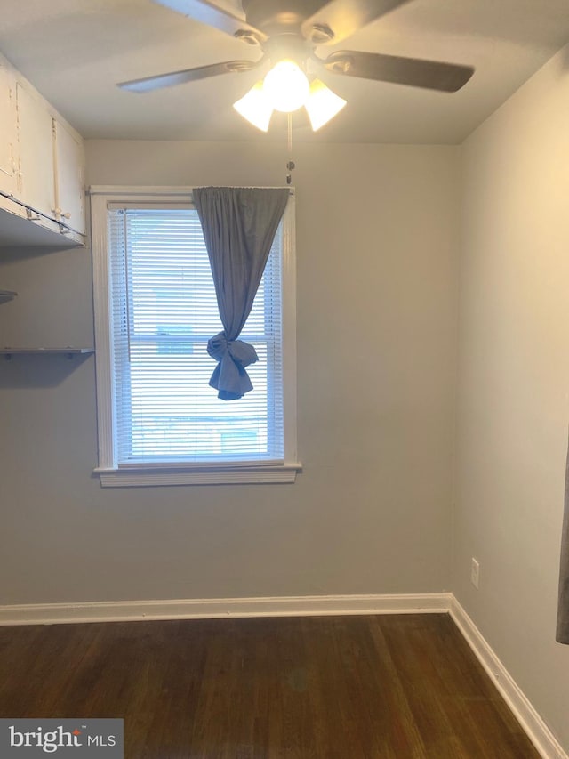 unfurnished room with ceiling fan and dark hardwood / wood-style floors