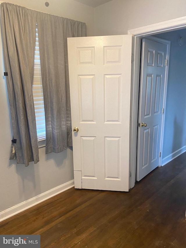 unfurnished bedroom featuring dark wood-type flooring