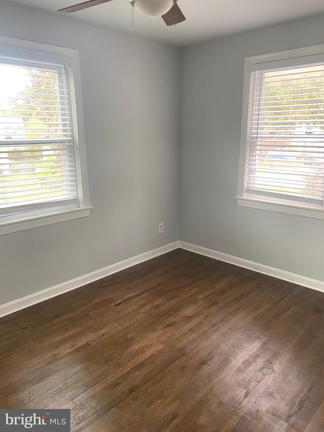 spare room with ceiling fan and dark hardwood / wood-style floors