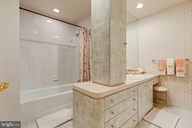 bathroom featuring vanity, shower / bath combo with shower curtain, and tile patterned flooring