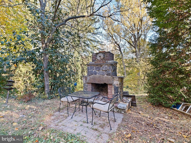 view of patio with an outdoor stone fireplace