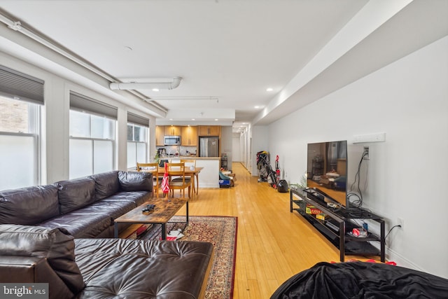 living room with recessed lighting and light wood-type flooring