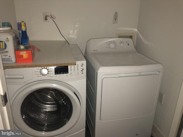 laundry area featuring washing machine and clothes dryer